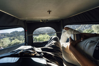 Young couple on road trip resting in van