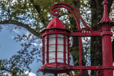 Low angle view of red bell tower at park against sky