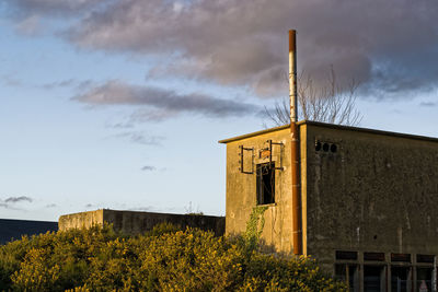 Low angle view of abandoned building against sky