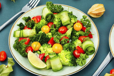 Vitamin salad with broccoli, tomato, cucumber and physalis. healthy food