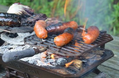 Burnt sausages on barbecue grill