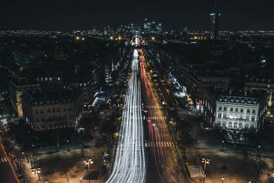 High angle view of light trails in illuminated city at night