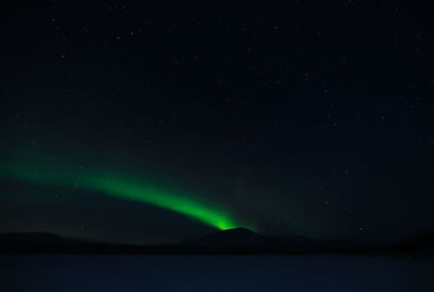 Low angle view of illuminated light against sky at night