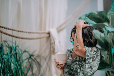 Midsection of woman holding plant