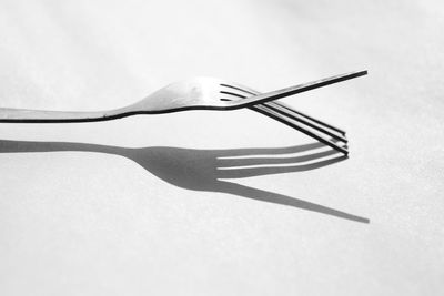 High angle view of umbrella on table against white background