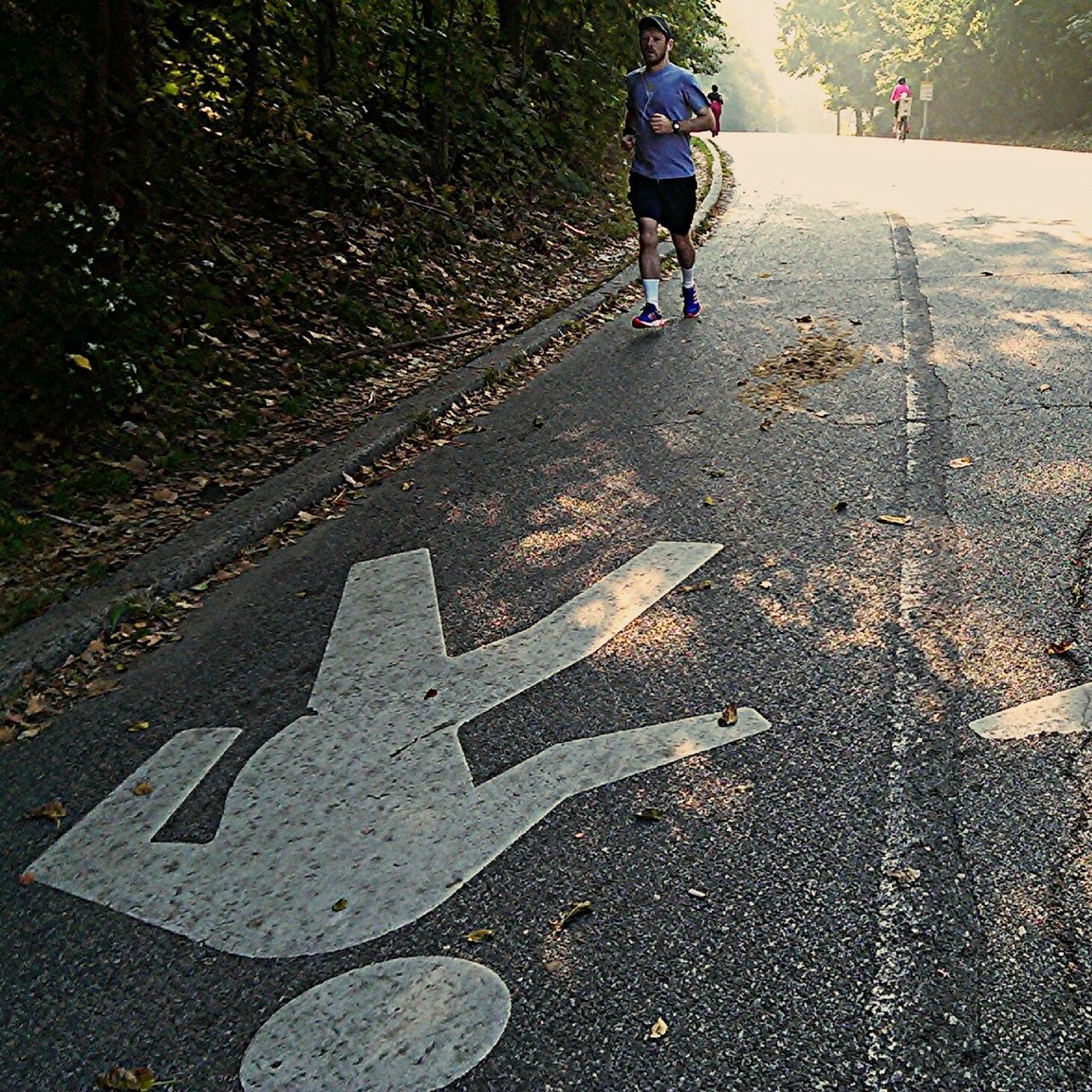 lifestyles, street, road, full length, walking, leisure activity, road marking, casual clothing, shadow, childhood, men, sunlight, on the move, transportation, day, boys, asphalt, outdoors