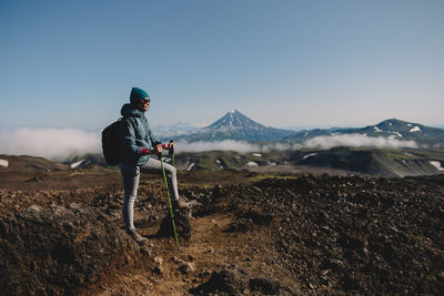 Man on landscape against mountain range