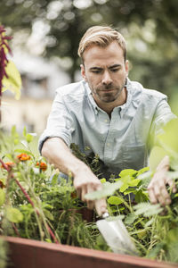 Mid adult man gardening outdoors