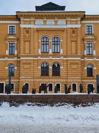 Building on snow covered field in city