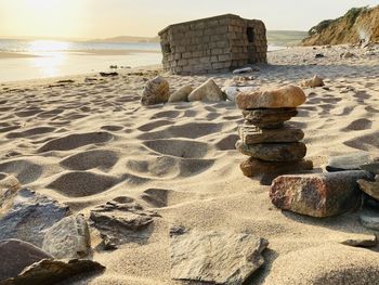 Scenic view of rocks on beach against sky