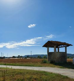 Built structure on field against sky