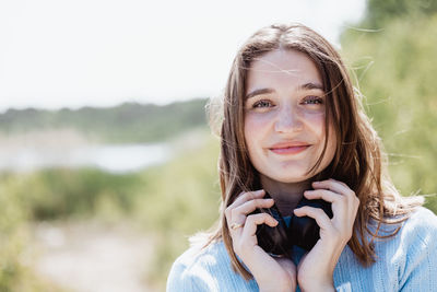 Portrait of young woman standing outdoors