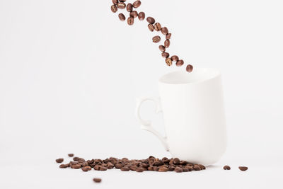 Close-up of coffee cup over white background
