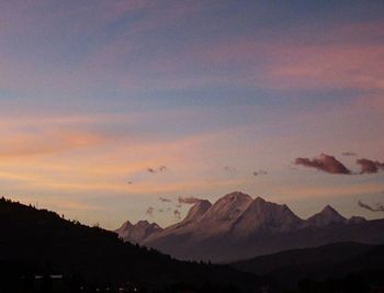 Scenic view of mountains against sky at sunset