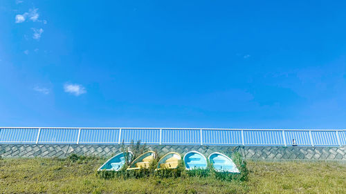 Built structure on field against blue sky