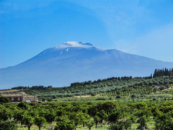 Scenic view of mountains against clear blue sky