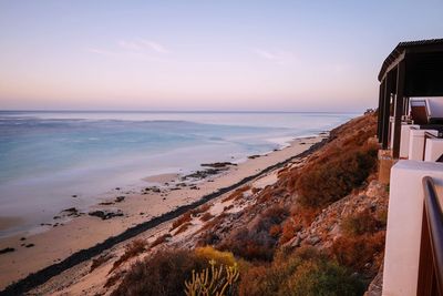 Scenic view of beach against sky during sunset