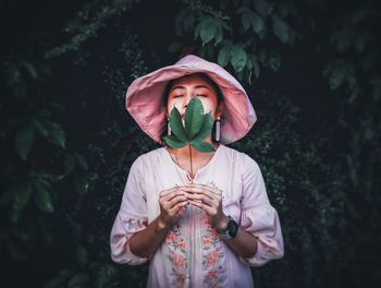 Midsection of woman holding plant