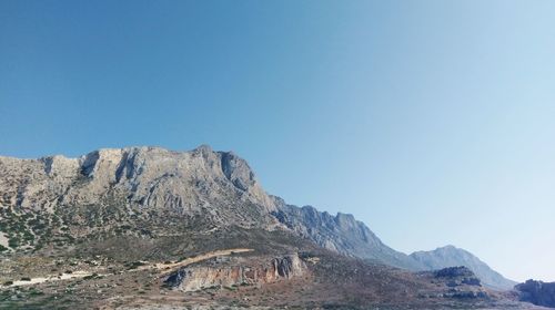 Low angle view of mountain against clear blue sky