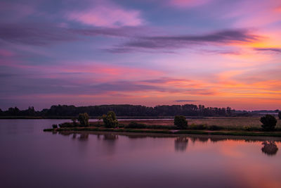 Scenic view of lake against sky during sunset