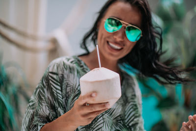 Portrait of a smiling young woman holding ice cream