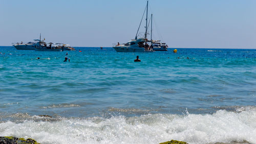 Sailboat in sea against clear sky