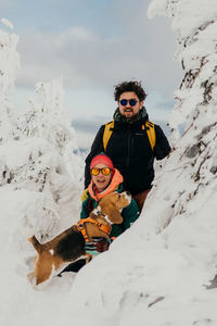 Couple and a dog on snow