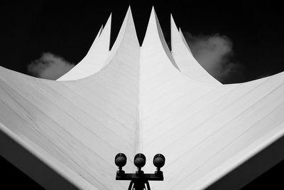 Low angle view of lighting equipment on building against sky