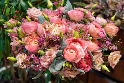 Close-up of beautiful multi-colored bouquet of mixed roses and other flowers in a shop. 