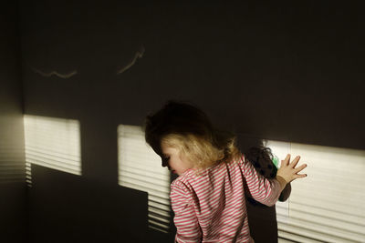 Girl looking away while standing at home
