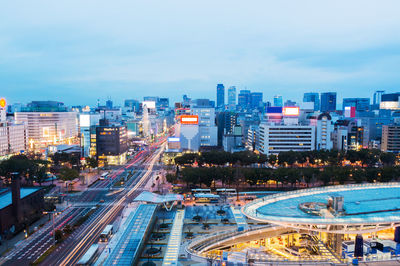 High angle view of illuminated city street against sky