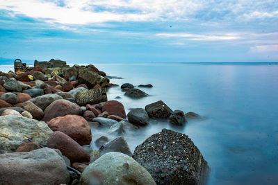 Rocks in sea against sky