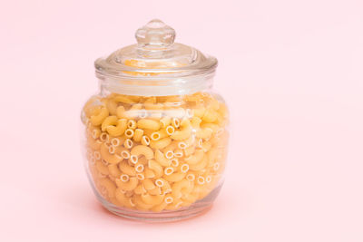 Close-up of food in jar against white background