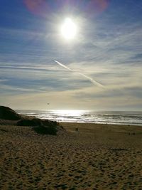 Scenic view of beach against sky during sunset