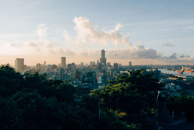 Cityscape against cloudy sky