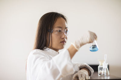 Scientist female with sample and tubes in a lab