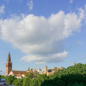 Buildings against cloudy sky