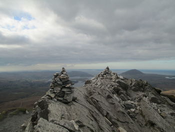 Scenic view of mountains against cloudy sky