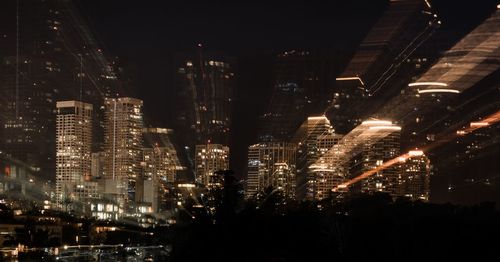 Aerial view of illuminated buildings in city at night