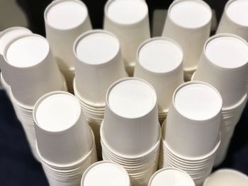 High angle view of stacked disposable cups on black background