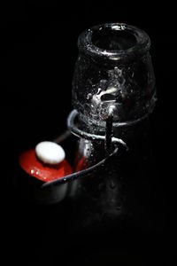 Close-up of water drops on glass against black background
