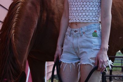 Low section of woman standing outdoors