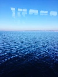 Scenic view of sea against blue sky