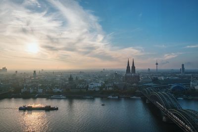 Scenic view of river against cloudy sky