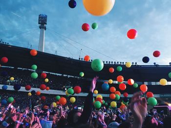 Group of people against balloons in city