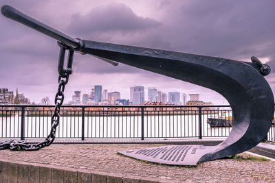 Bridge over river against buildings in city