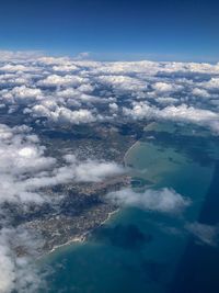 Aerial view of sea and landscape against sky