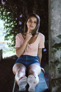 Portrait of a young woman sitting outdoors