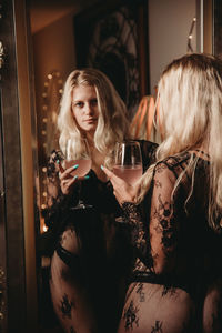 Beautiful young woman drinking from glass