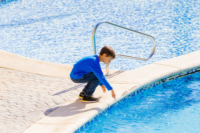 Full length of boy at poolside